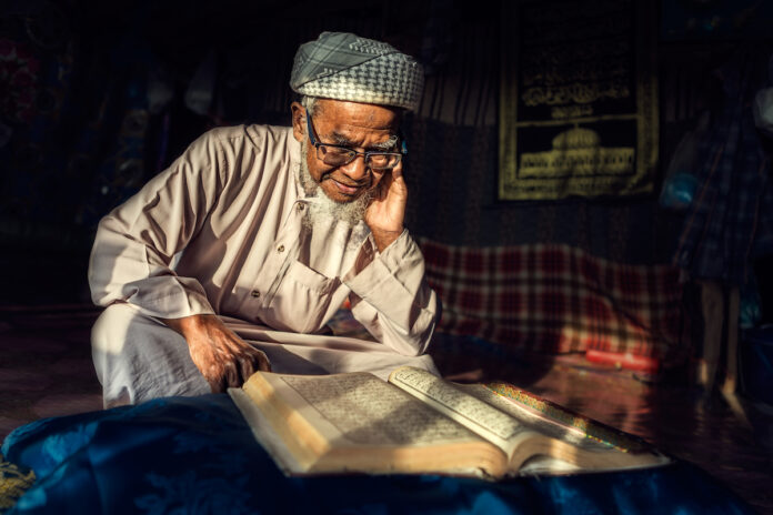 Vieil homme lisant le Coran